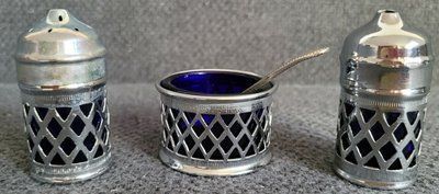 A vintage set of salt and pepper shakers and mustard dish made in England
