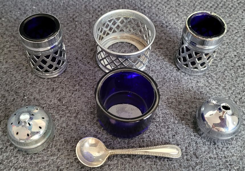 A vintage set of salt and pepper shakers and mustard dish made in England
