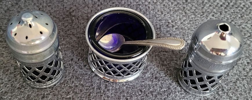 A vintage set of salt and pepper shakers and mustard dish made in England