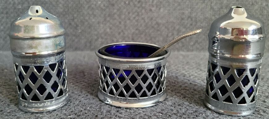 A vintage set of salt and pepper shakers and mustard dish made in England