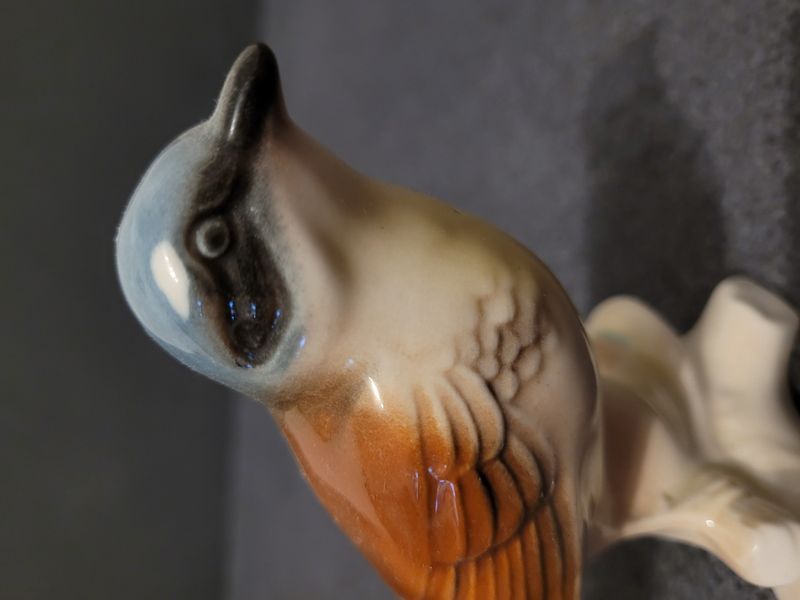 Bird on a branch. Porcelain.Hand-painted