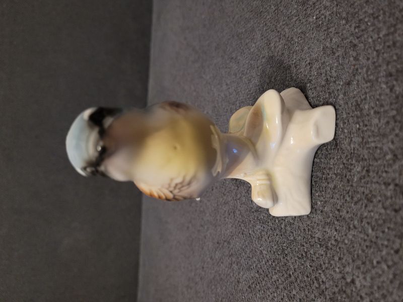 Bird on a branch. Porcelain.Hand-painted