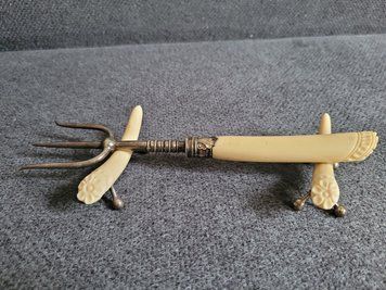 Antique serving fork on a stand