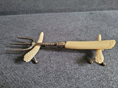 Antique serving fork on a stand
