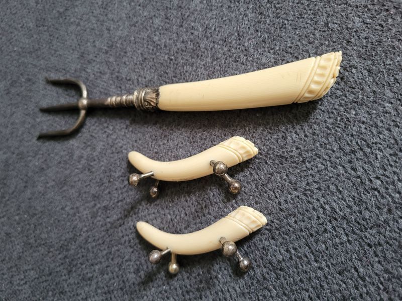 Antique serving fork on a stand