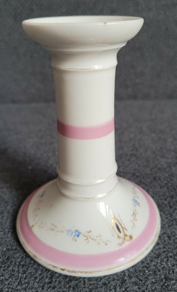 A pair of pink candlesticks made of French porcelain