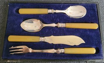 Antique silver-plated serving utensils with a silver rim