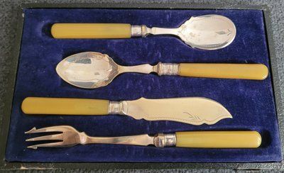 Antique silver-plated serving utensils with a silver rim