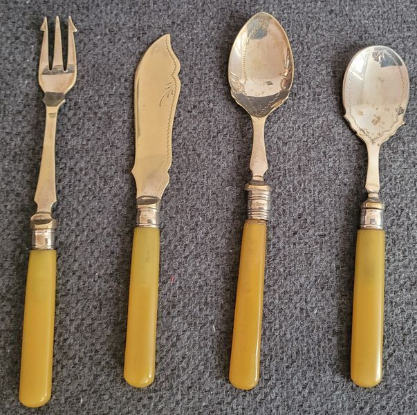Antique silver-plated serving utensils with a silver rim