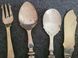 Antique silver-plated serving utensils with a silver rim