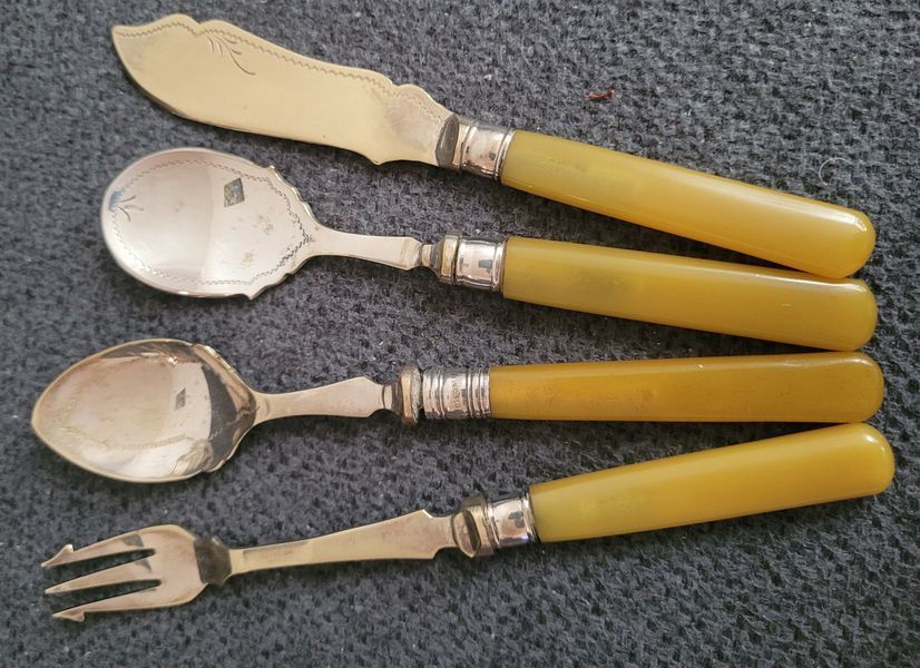 Antique silver-plated serving utensils with a silver rim