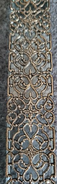 Vintage glass decor with metal filigree.