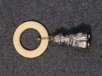 Vintage baby rattle made of white metal