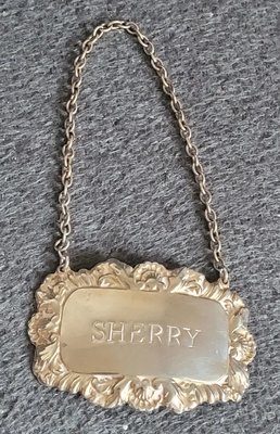 Vintage silver label for a decanter with a chain.