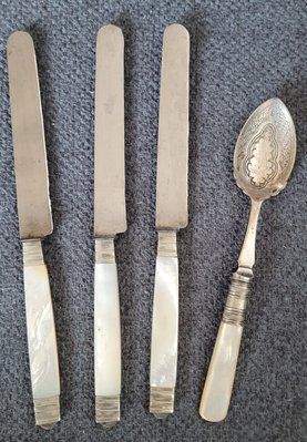Antique cutlery with mother-of-pearl handles.