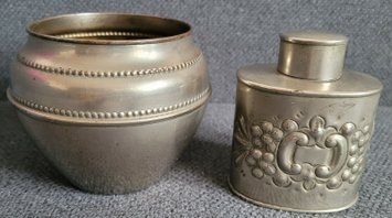 Vintage white metal sugar bowl and tea storage bottle.