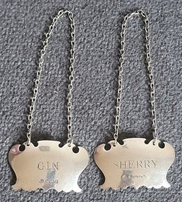 Two vintage silver labels for a decanter with a chain.