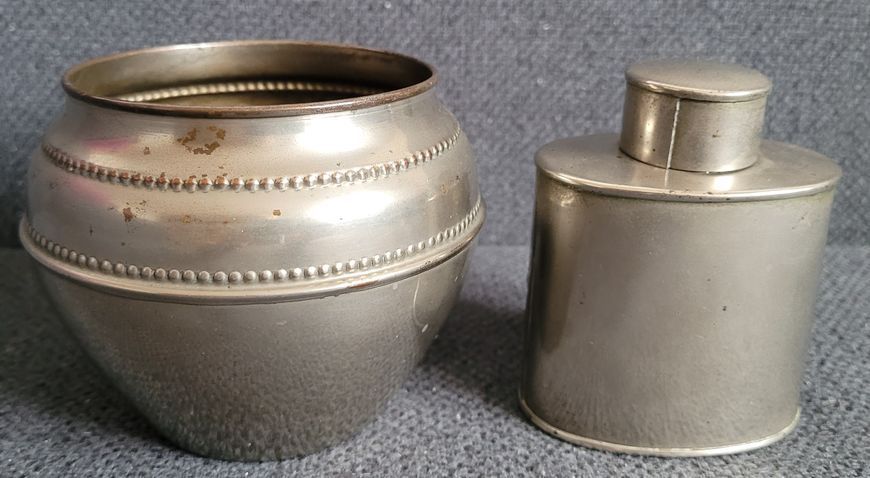 Vintage white metal sugar bowl and tea storage bottle.