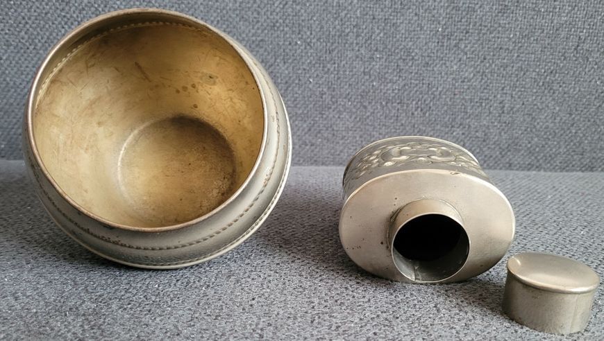 Vintage white metal sugar bowl and tea storage bottle.