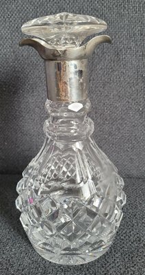 Antique crystal decanter with 925 sterling silver rim.