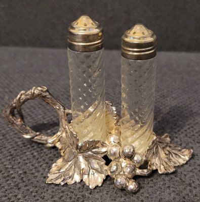 Vintage glass salt and pepper shakers on a metal stand