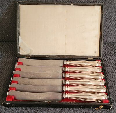 A rare set of snack knives with a silver handle .