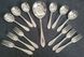 A set Goldsmiths & Silversmiths Co Ltd of antique silver-plated spoons with a large serving spoon