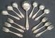 A set Goldsmiths & Silversmiths Co Ltd of antique silver-plated spoons with a large serving spoon
