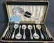 A set Goldsmiths & Silversmiths Co Ltd of antique silver-plated spoons with a large serving spoon