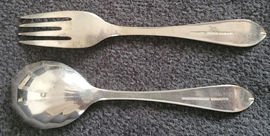 A set Goldsmiths & Silversmiths Co Ltd of antique silver-plated spoons with a large serving spoon