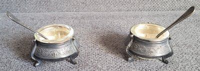 Two vintage nickel silver salt bowls with spoons.