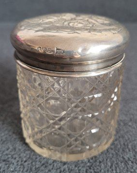 Antique crystal jar with silver lid.