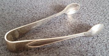 Vintage silver-plated sugar tongs.