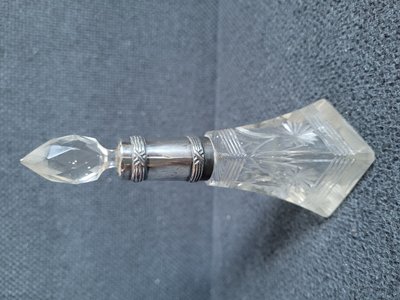 Antique crystal incense bottle with silver rim and crystal lid.