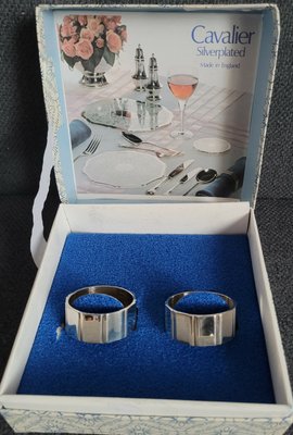 A set of 2 vintage silver-plated Cavalier napkin rings in the original box.