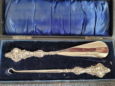 Antique set of silver shoe horn and button hook with sterling silver handle in the original case.