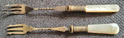 Two antique silver-plated forks for pickled cucumbers with a pearl handle