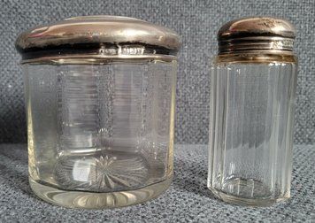 Two vintage jars with silver lids.
