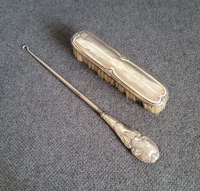 Antique silver clothes brush and hook from the early 20th century